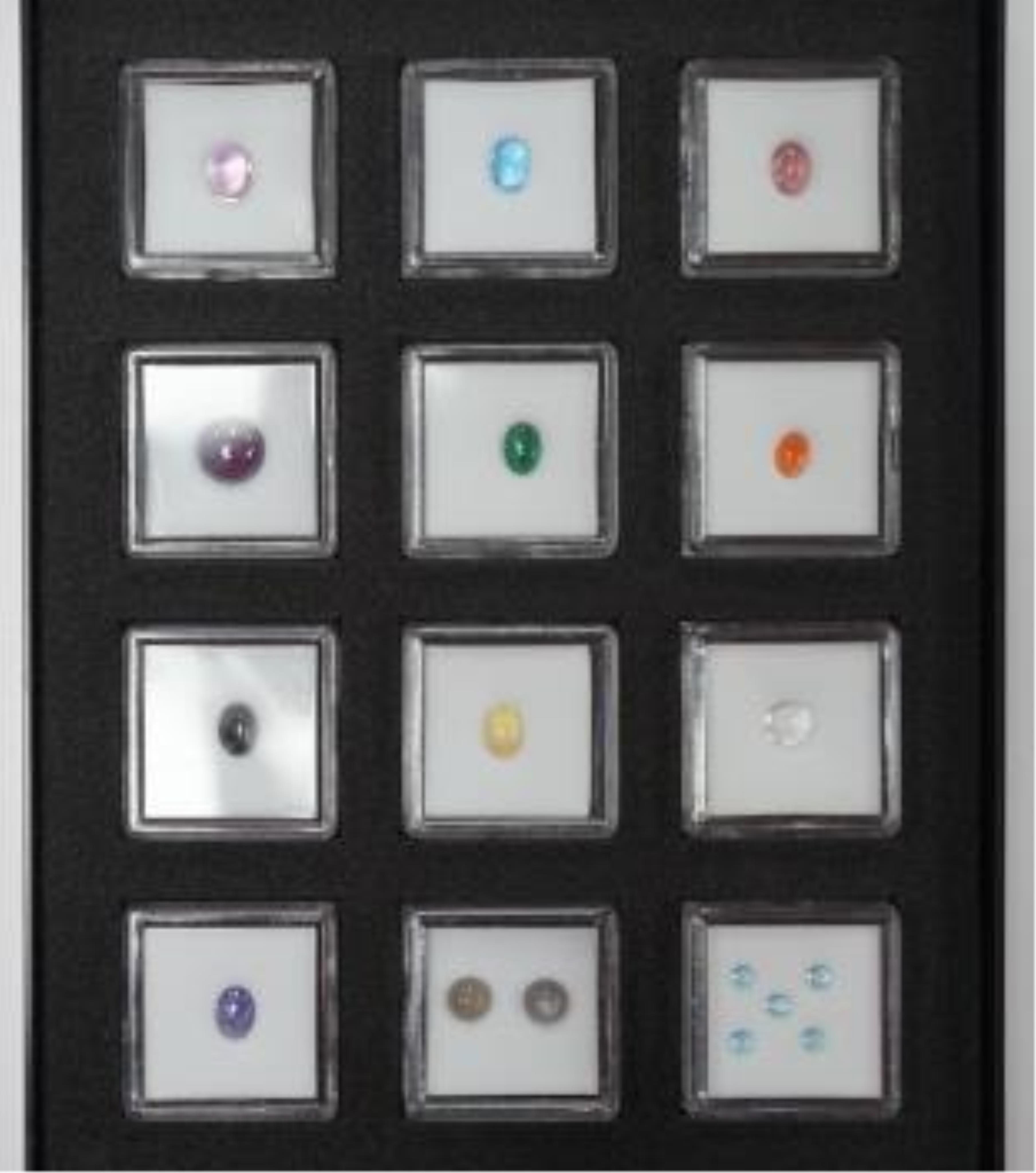 Three boxes containing unmounted cut gemstones including topaz, citrine, peridot, zircon, moonstone, etc. Condition - fair